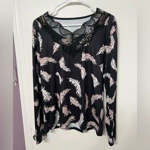 Beautiful women’s black long sleeve with falling feathers and a lace trim